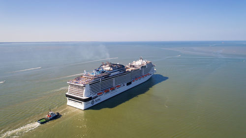 High angle view of people sailing on sea against sky