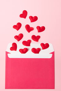 High angle view of heart shapes on pink background