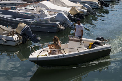 People on boat moored at sea