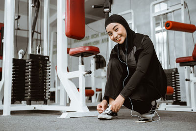 Young woman exercising in gym