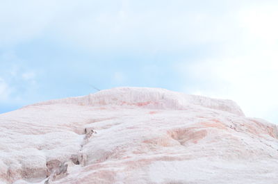 Low angle view of rock formation against sky