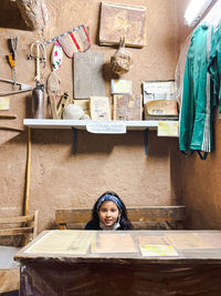 Portrait of smiling young woman standing in store