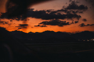 Scenic view of dramatic sky over silhouette landscape