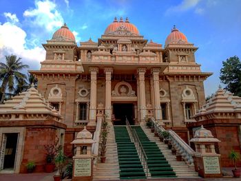 Facade of temple against cloudy sky