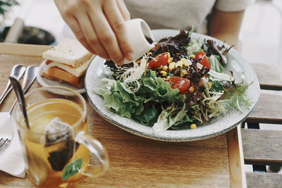 Close-up of hand holding food on table