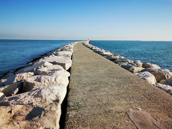 Scenic view of sea against clear blue sky. jetty. 