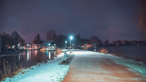 View of illuminated city at night during winter