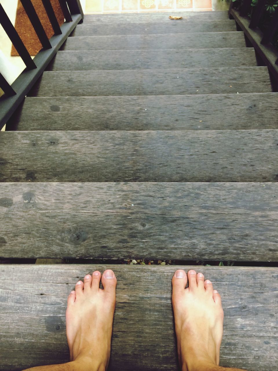 low section, person, personal perspective, human foot, barefoot, part of, unrecognizable person, wood - material, lifestyles, boardwalk, leisure activity, high angle view, pier, cropped, indoors