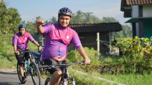 Portrait of people riding bicycle