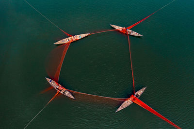 Aerial view of boats tied together in sea