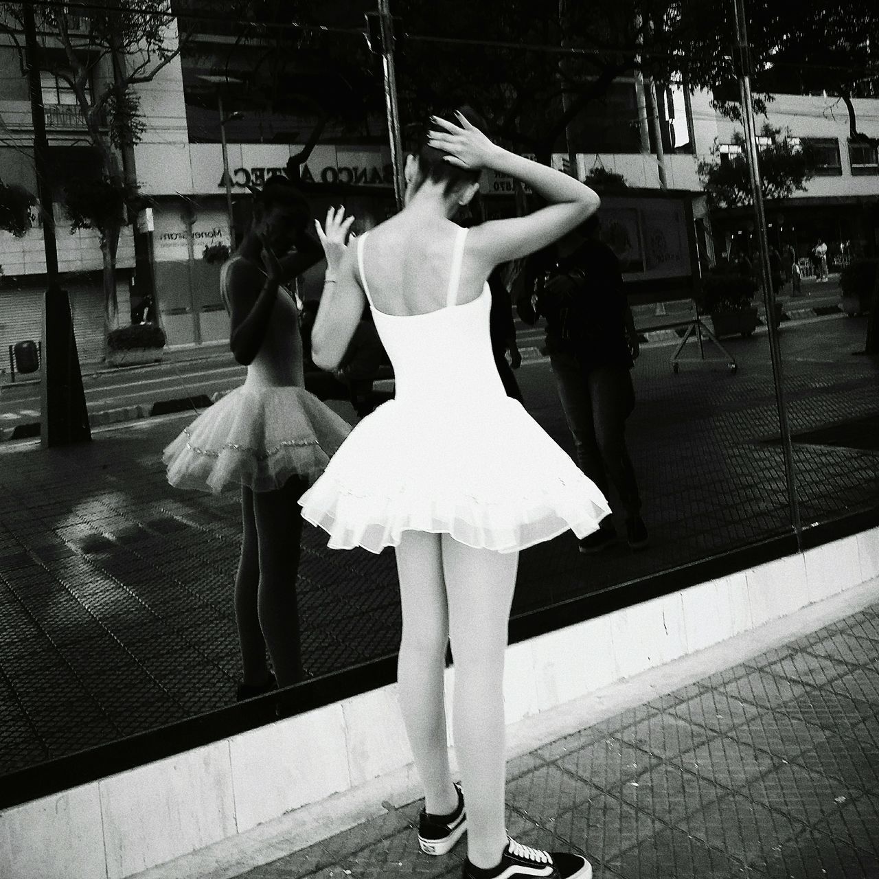 REAR VIEW OF WOMAN WITH UMBRELLA STANDING ON STREET