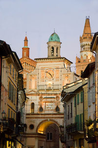Low angle view of buildings in city against sky