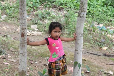 Portrait of cute girl standing in park