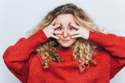 Close-up portrait of woman with teddy bear against white background