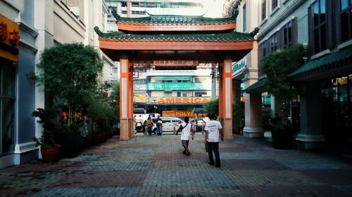 People walking on sidewalk in city