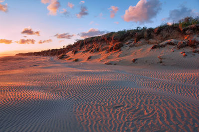 Scenic view of desert against sky during sunset