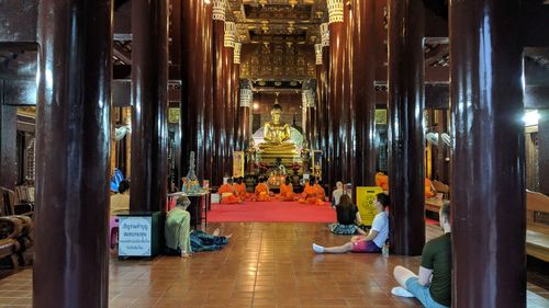 People meditating in buddhist temple