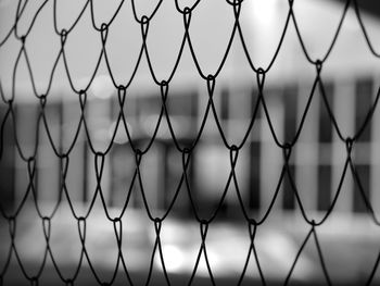 Close-up of chainlink fence against sky