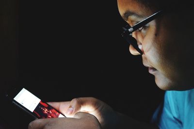 Close-up of woman using mobile phone at night