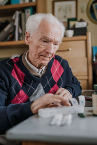 Midsection of man sitting on table