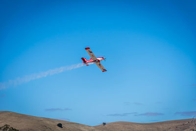 Low angle view of airplane flying in sky