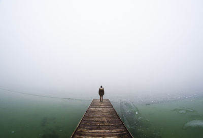 Man on foggy day against sky