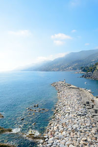 Pier of the touristic harbor of the sea village of camogli, italy that faces paradise bay