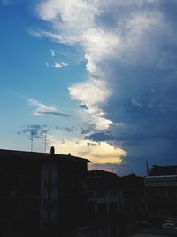 Low angle view of silhouette buildings against sky