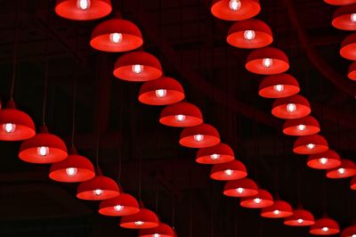 Low angle view of illuminated lights hanging on ceiling