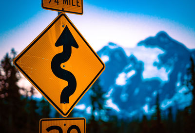 Low angle view of road sign against sky