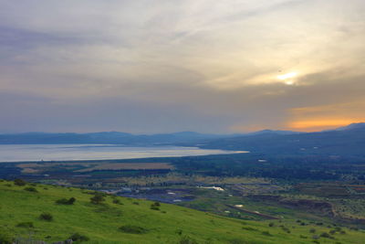 Scenic view of field and mountains against sky