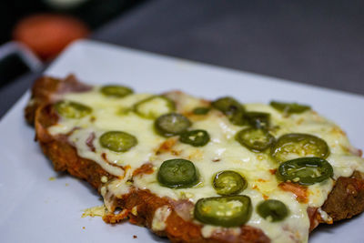 Close-up of pizza in plate on table