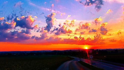 Road against dramatic sky during sunset