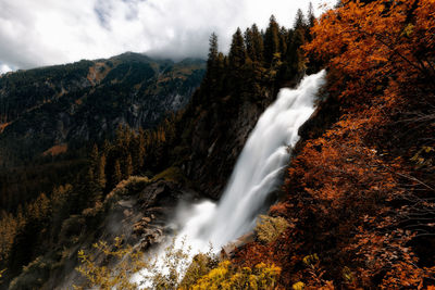 Scenic view of waterfall against sky