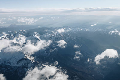 Aerial view of snowcapped mountains against sky