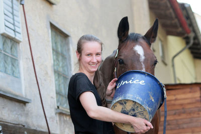 Portrait of smiling young woman in stable