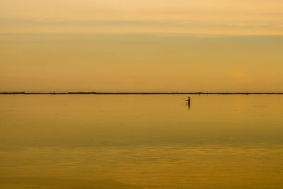 Scenic view of sea against orange sky