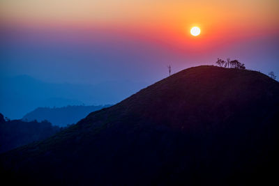 Silhouette mountains against sky during sunset