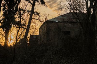 Abandoned building against sky during sunset