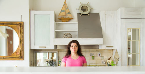 Portrait of young woman sitting at home