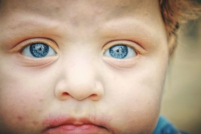 Close-up portrait of cute baby girl with blue eyes