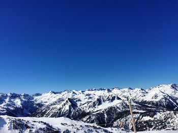 Snowcapped mountains against blue sky