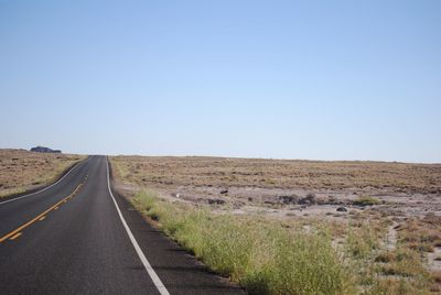 Road amidst landscape against clear sky