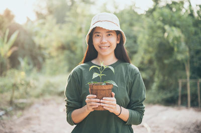 Portrait of a smiling young woman holding ice cream