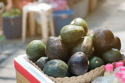 Close-up of fruits in basket on table at market