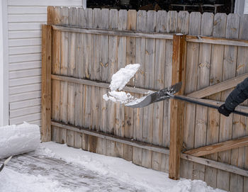 White snow covered wood against building