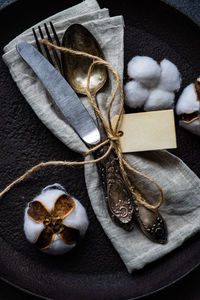 Close-up of antique cutlery with napkin in plate