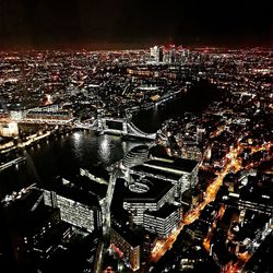 High angle view of city lit up at night