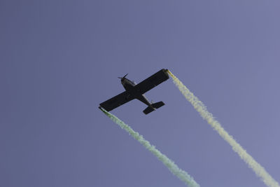 Low angle view of airplane flying against clear sky