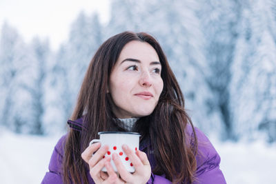 Portrait of young woman using mobile phone